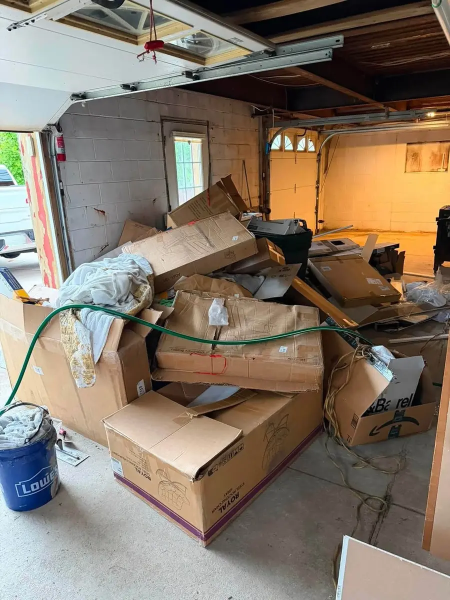 Garage filled with boxes and household junk before cleanout