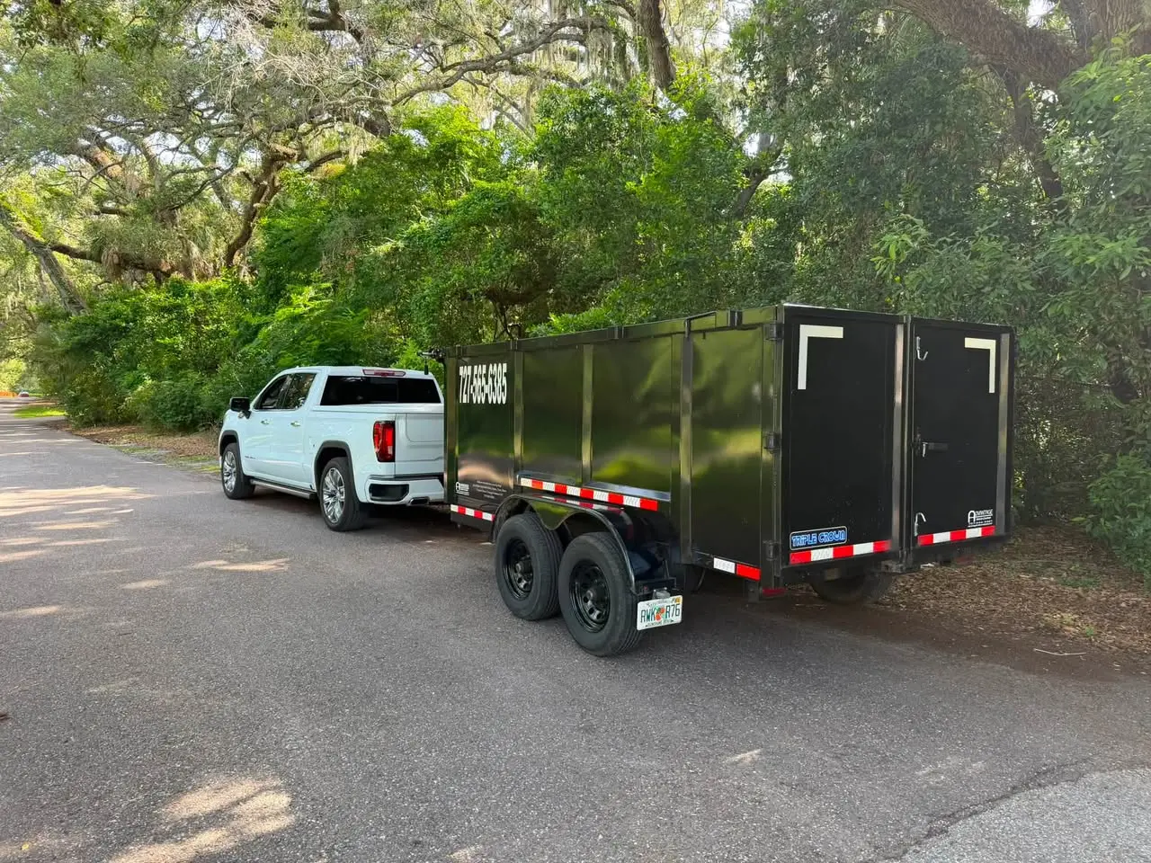 Safety Harbor Premier Junk Removal truck and dump trailer ready for a local pickup